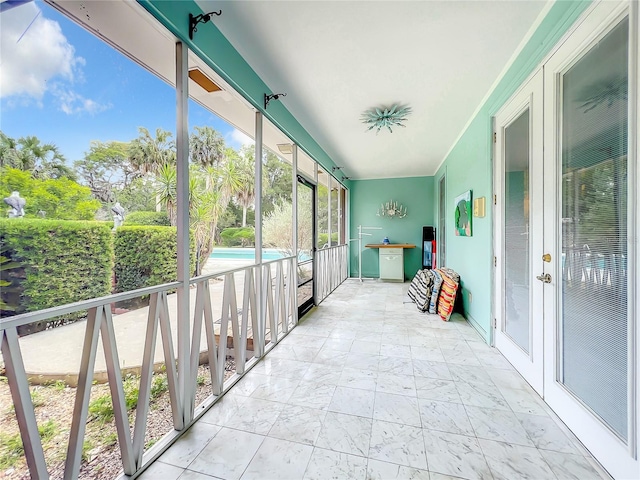 unfurnished sunroom with french doors