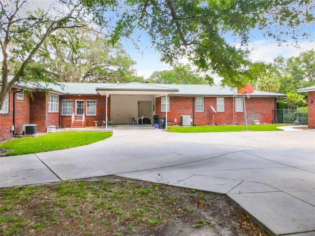 ranch-style house with a carport and central air condition unit