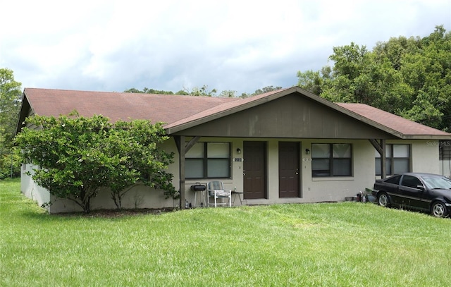 single story home featuring a front lawn and a porch