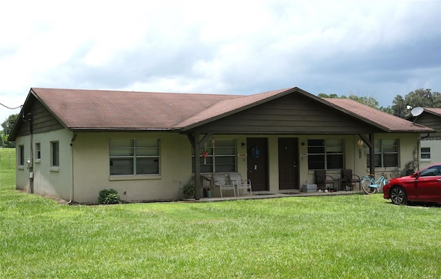 view of front of property with covered porch and a front yard