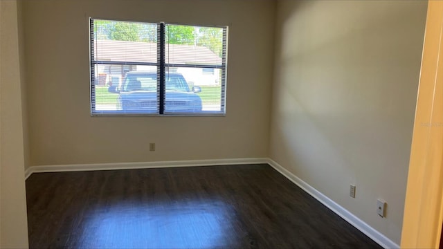 unfurnished room featuring dark hardwood / wood-style flooring