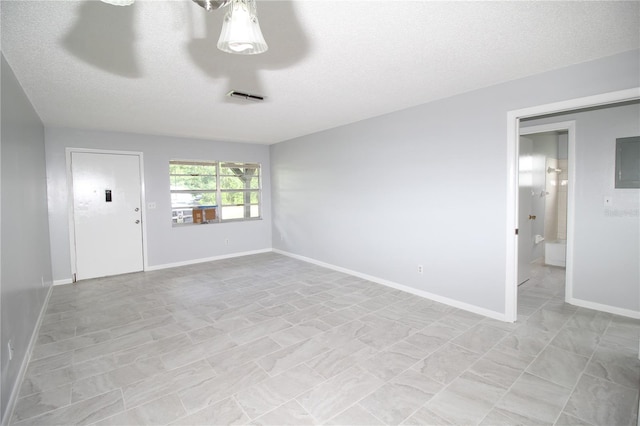 empty room featuring a textured ceiling