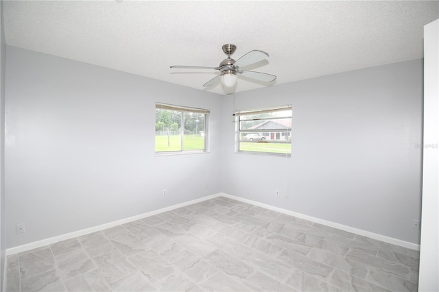 unfurnished room featuring a textured ceiling and ceiling fan