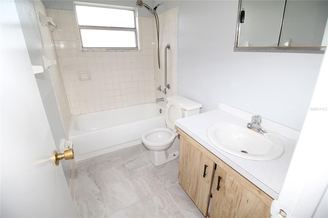 full bathroom featuring tiled shower / bath combo, toilet, and vanity