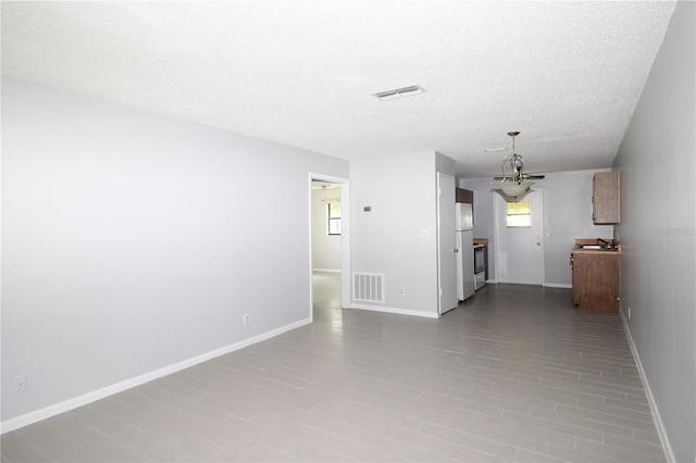 unfurnished living room with a textured ceiling and hardwood / wood-style flooring