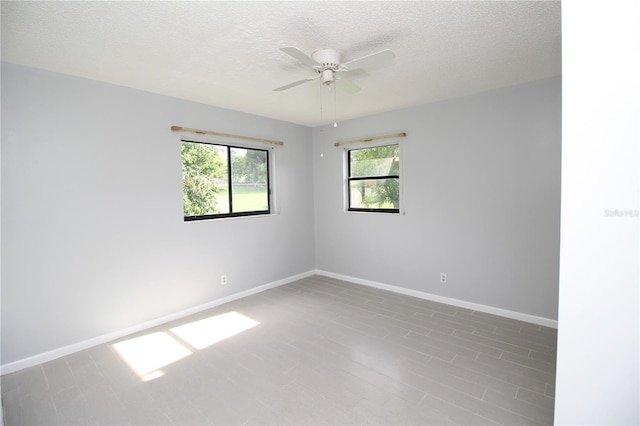 unfurnished room featuring ceiling fan and a textured ceiling