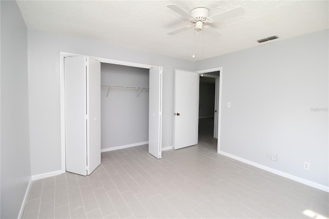 unfurnished bedroom featuring ceiling fan, a closet, and a textured ceiling