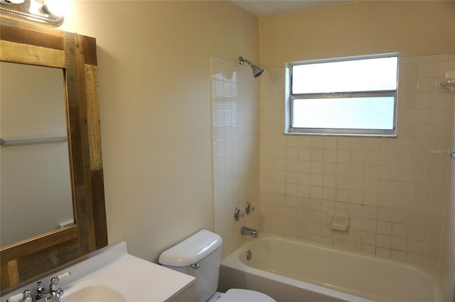 full bathroom with toilet, vanity, and tiled shower / bath