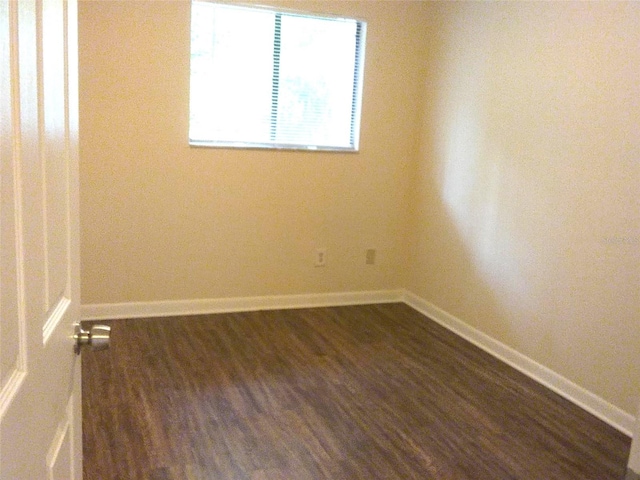 empty room featuring dark hardwood / wood-style floors