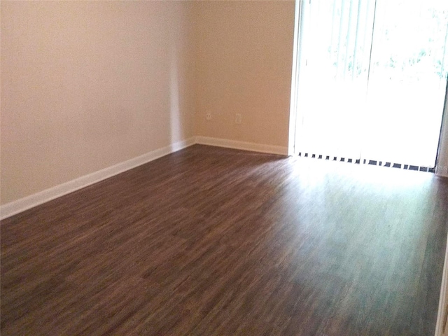 unfurnished room with dark hardwood / wood-style floors