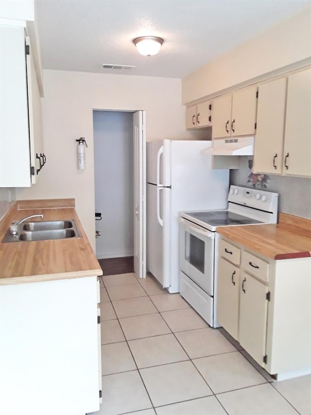 kitchen featuring cream cabinets, white electric range oven, sink, and light tile flooring