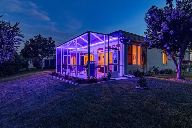 exterior space featuring a front yard and a lanai