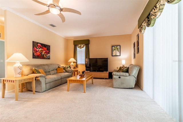 living room featuring ornamental molding, ceiling fan, and light colored carpet