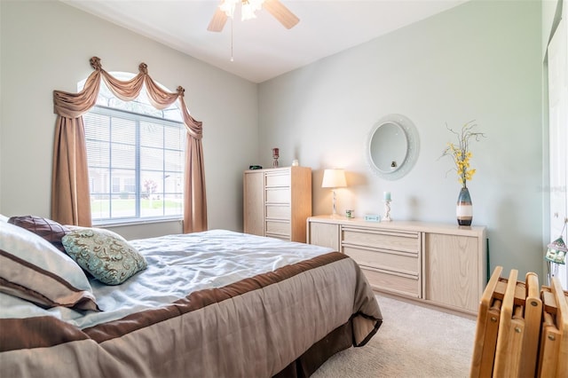 bedroom with ceiling fan and light colored carpet