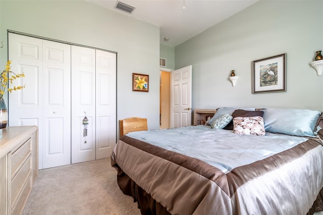 bedroom with a closet and light colored carpet