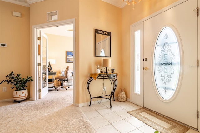 entrance foyer with ornamental molding and light tile floors