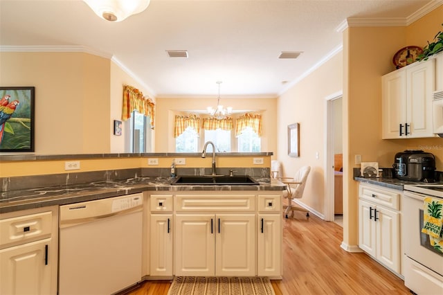 kitchen featuring light hardwood / wood-style floors, white appliances, sink, and a chandelier