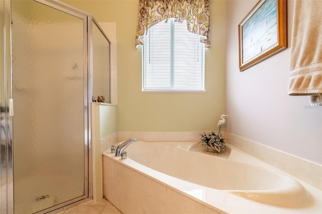 bathroom featuring tile flooring, separate shower and tub, and a wealth of natural light