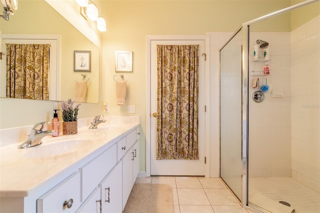 bathroom with tile floors, vanity with extensive cabinet space, walk in shower, and double sink