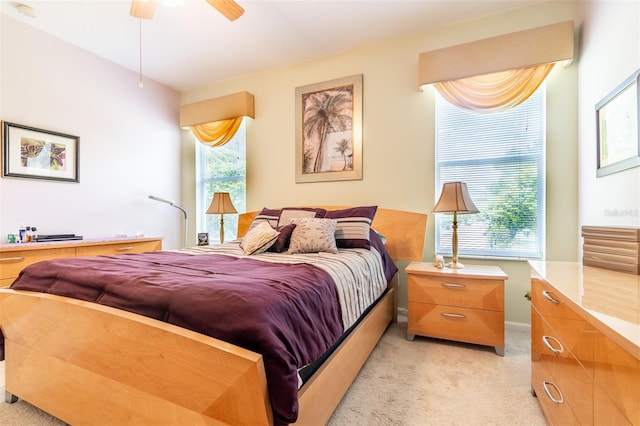 bedroom featuring light colored carpet and ceiling fan