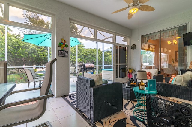 sunroom featuring ceiling fan and a healthy amount of sunlight