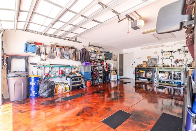 garage with a garage door opener and a workshop area