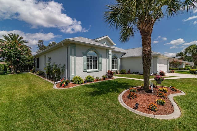 single story home featuring a front lawn and a garage