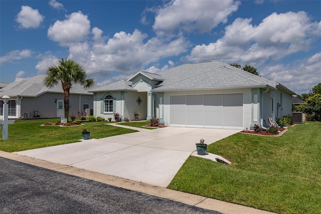 ranch-style home with a front yard, central AC, and a garage