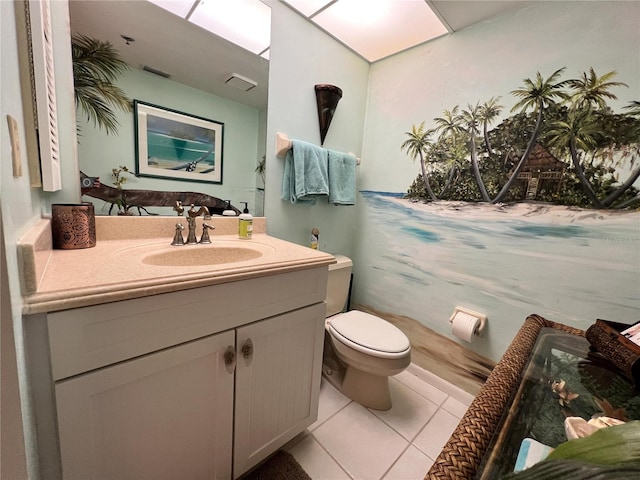 bathroom featuring tile patterned flooring, vanity, and toilet