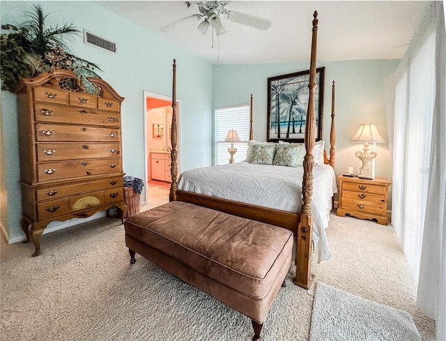 carpeted bedroom with ensuite bath, ceiling fan, and lofted ceiling