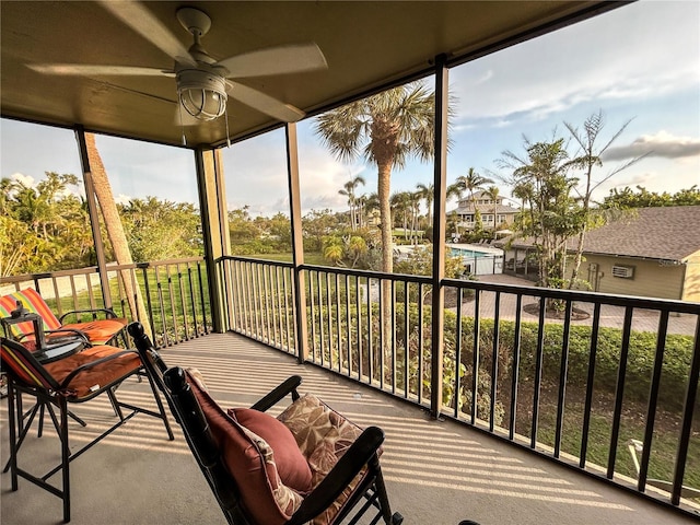 sunroom / solarium featuring ceiling fan