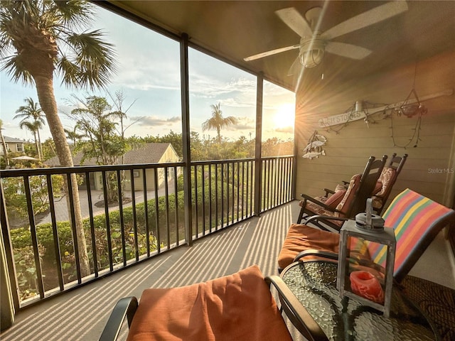 balcony at dusk featuring ceiling fan