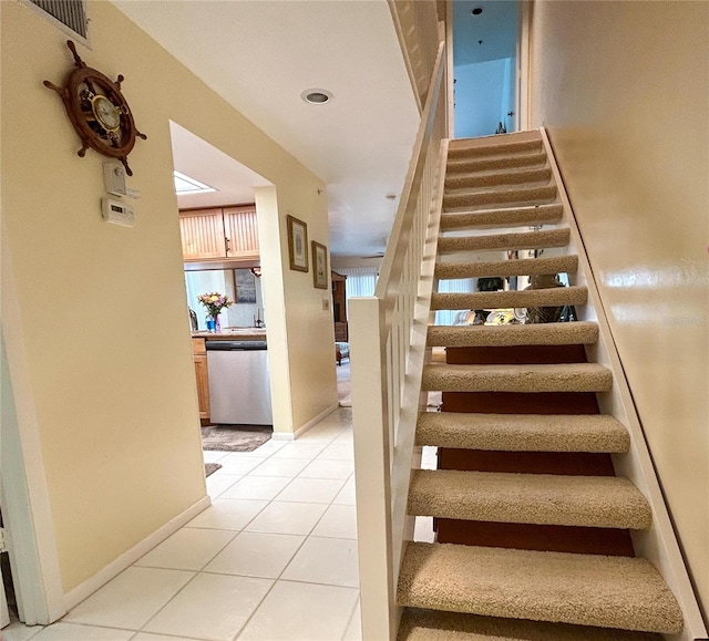 stairway featuring tile patterned flooring