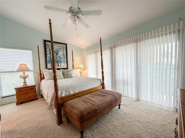 carpeted bedroom featuring ceiling fan and vaulted ceiling