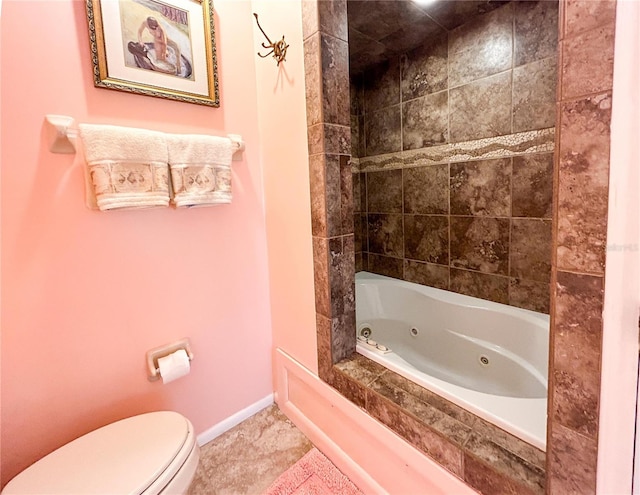 bathroom with tile patterned floors, toilet, and tiled shower / bath