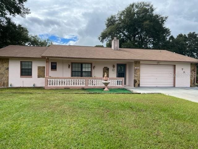 ranch-style home with a front lawn and a garage