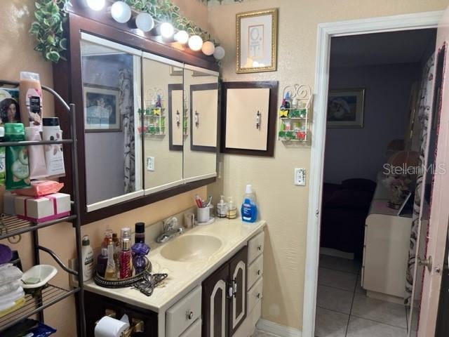 bathroom with tile flooring and vanity