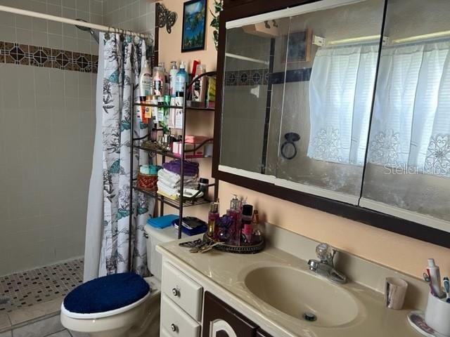 bathroom featuring curtained shower, toilet, vanity, and a wealth of natural light