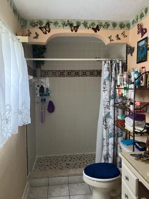 bathroom featuring toilet, a textured ceiling, tile floors, and a shower with shower curtain