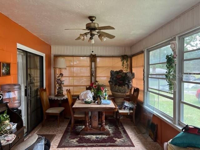 sunroom / solarium featuring ceiling fan