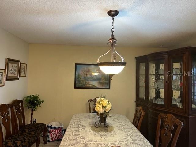 dining space with a textured ceiling