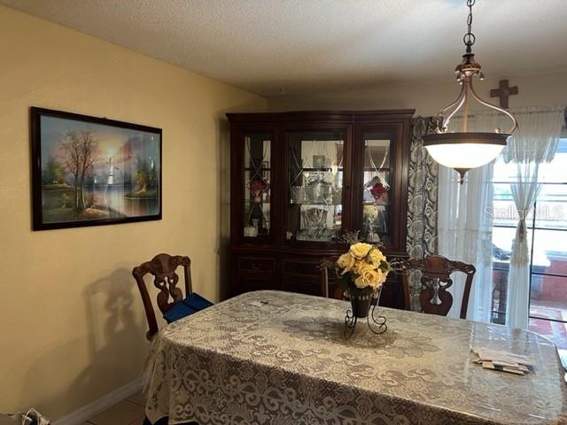 dining space featuring a textured ceiling