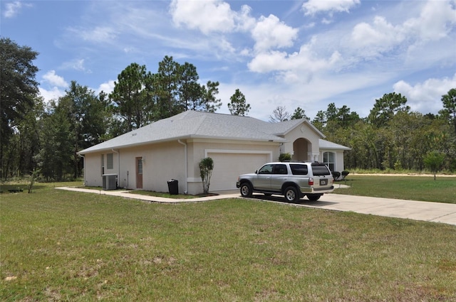 view of home's exterior featuring central AC unit, a yard, and a garage