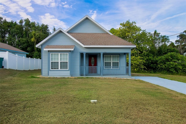 view of front of house with a porch and a front yard