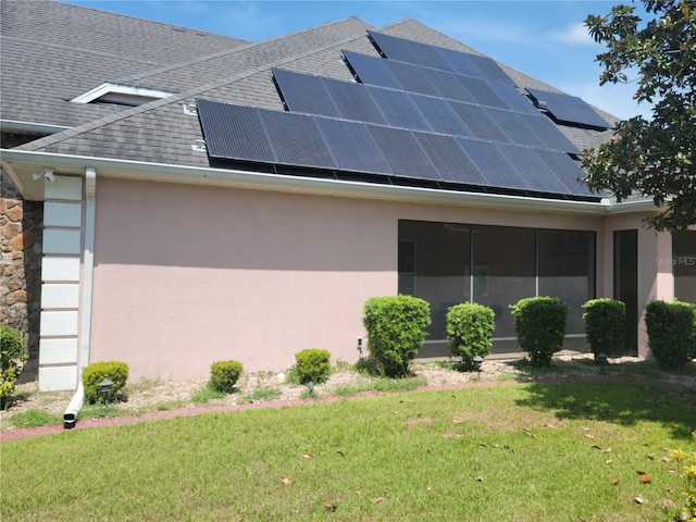 view of home's exterior featuring a yard and solar panels