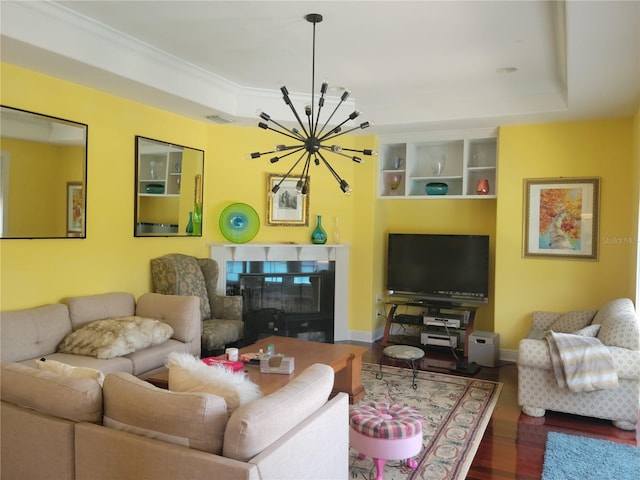 living room featuring hardwood / wood-style floors, a chandelier, and a tray ceiling