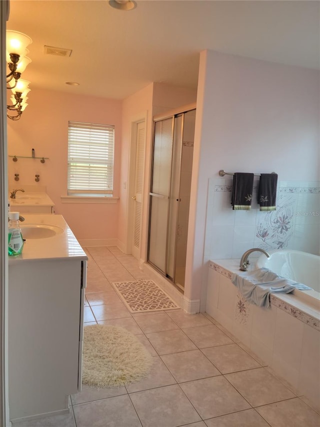 bathroom with independent shower and bath, dual vanity, and tile flooring