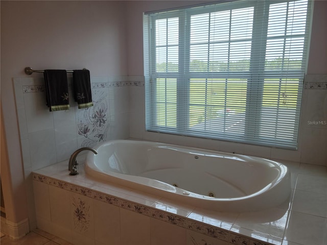 bathroom featuring tile flooring and tiled tub