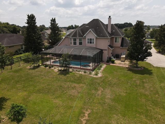 back of property with a lawn and a patio area