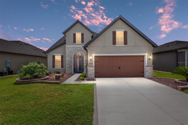 view of front of property with a lawn and a garage